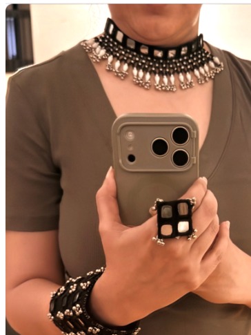 A black and silver statement choker worn with a simple outfit